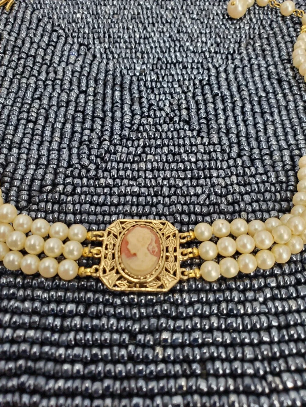 Vintage-style 3-strand pearl choker necklace with a prominent cameo centerpiece